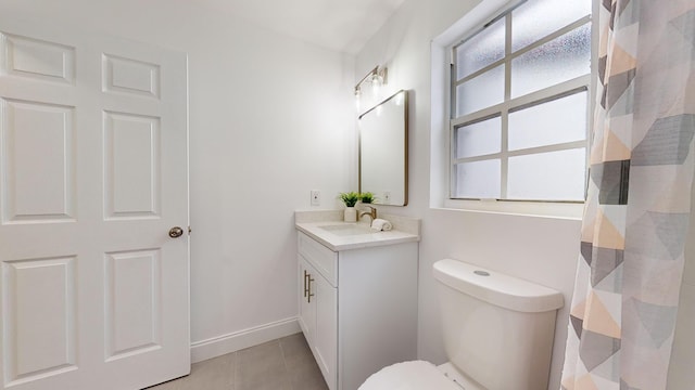 bathroom with toilet, tile patterned flooring, and vanity