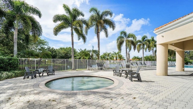 view of pool with a patio and a hot tub