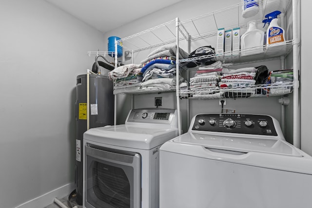 clothes washing area featuring washer and dryer and water heater