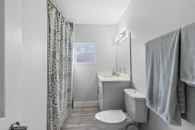 bathroom with vanity, hardwood / wood-style floors, and toilet