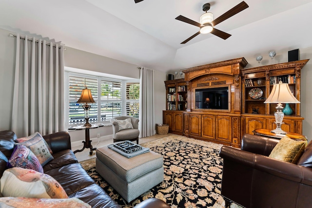 living room featuring ceiling fan, lofted ceiling, and tile patterned flooring