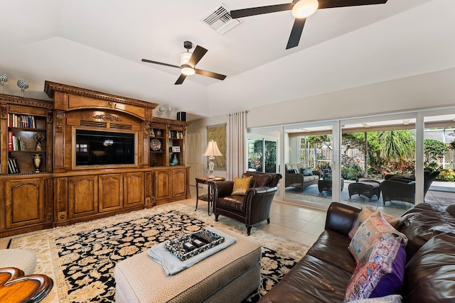 tiled living room featuring ceiling fan and a raised ceiling