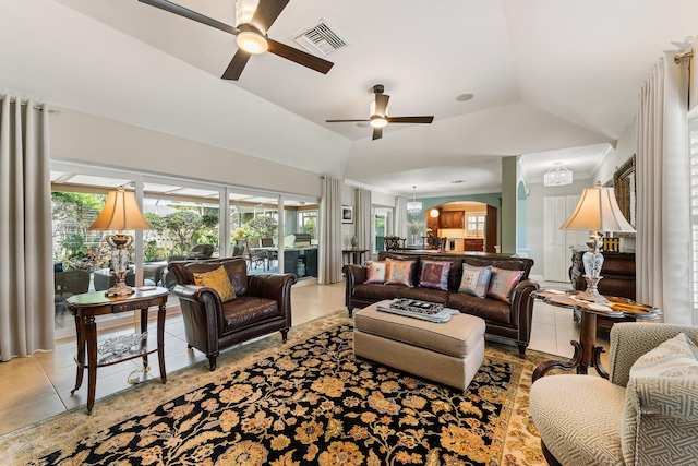 tiled living room with ceiling fan and lofted ceiling