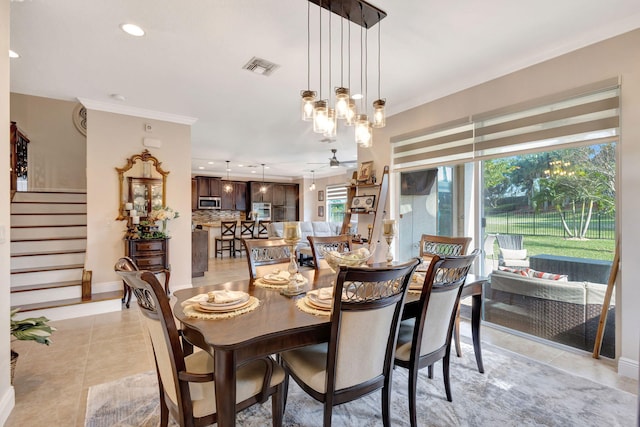 tiled dining room featuring ceiling fan and ornamental molding