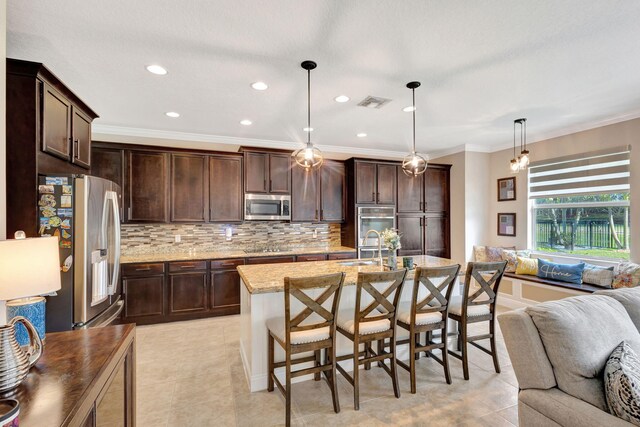 kitchen featuring appliances with stainless steel finishes, a breakfast bar, pendant lighting, crown molding, and light stone countertops