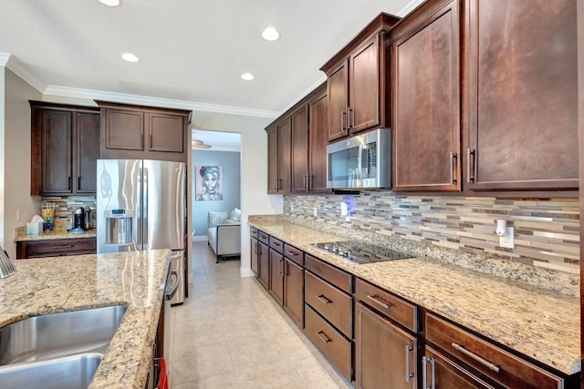 kitchen with crown molding, tasteful backsplash, light tile patterned floors, stainless steel appliances, and light stone countertops