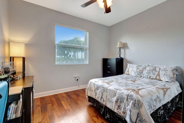 bedroom with dark wood-type flooring and ceiling fan