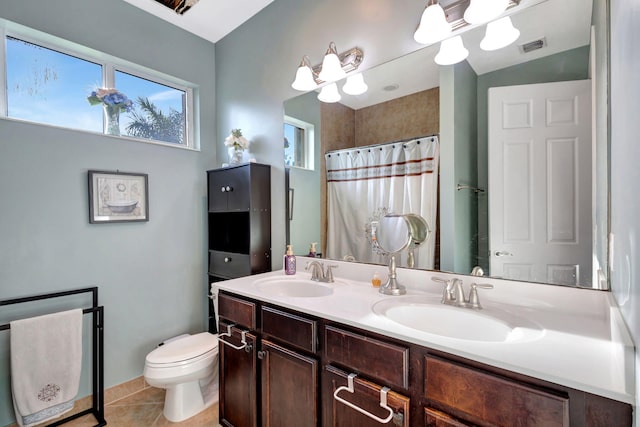 bathroom featuring vanity, a shower with shower curtain, tile patterned floors, and toilet