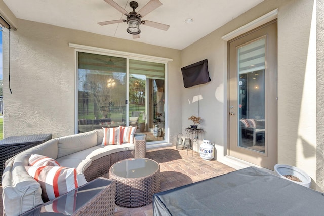 view of patio with an outdoor living space and ceiling fan