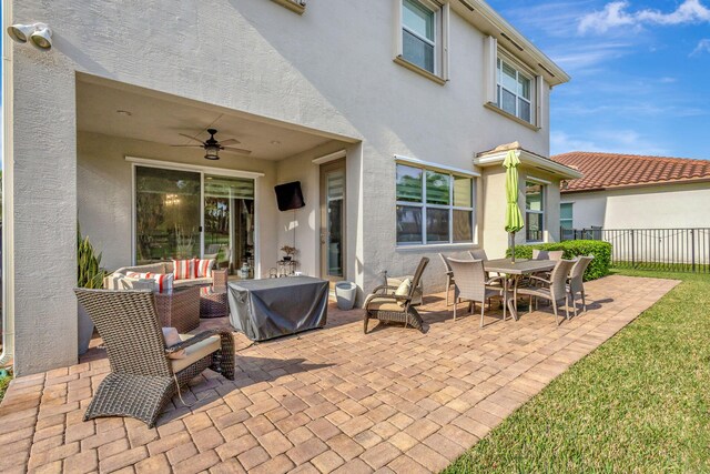 view of patio with ceiling fan and an outdoor living space