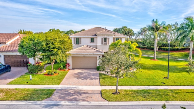 mediterranean / spanish-style home featuring a garage and a front yard