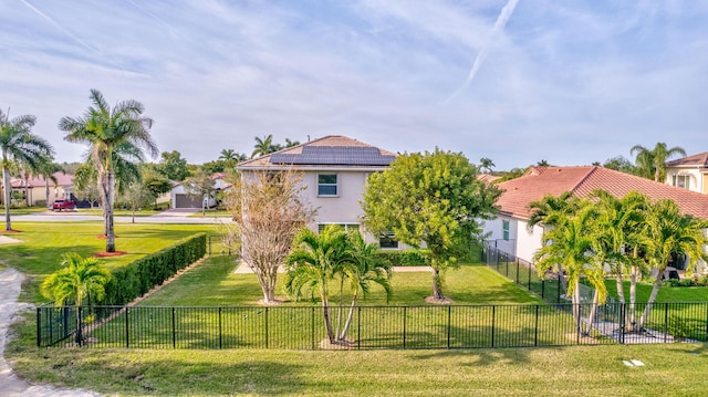 view of front of home featuring a front yard and solar panels