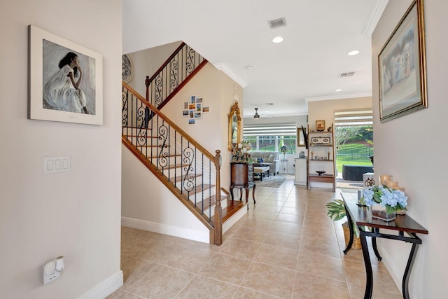 interior space featuring crown molding and light tile patterned floors