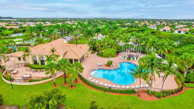 view of swimming pool featuring a patio and a yard