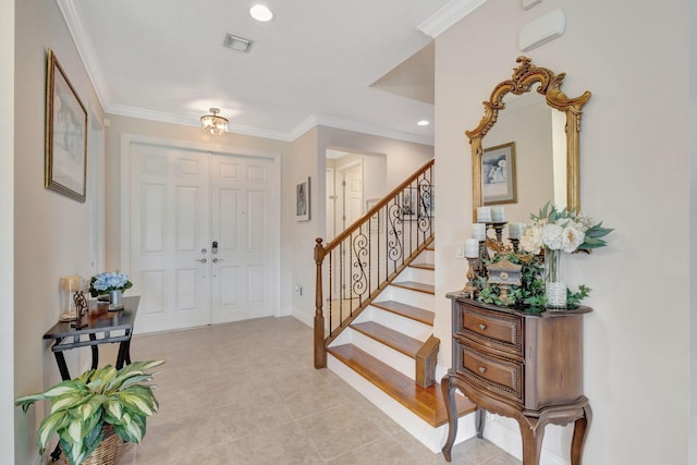 foyer featuring light tile patterned floors and crown molding