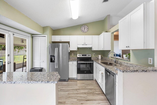 kitchen with sink, white cabinetry, lofted ceiling, and stainless steel appliances