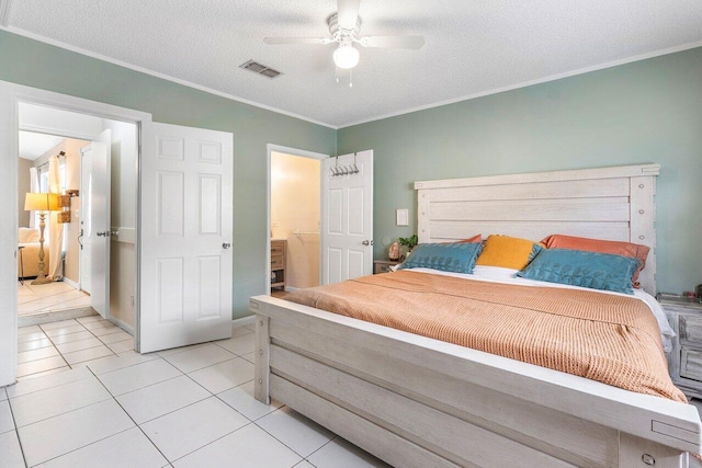 tiled bedroom with a textured ceiling, connected bathroom, ceiling fan, and ornamental molding