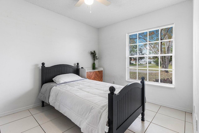 bedroom with light tile patterned flooring, a textured ceiling, and ceiling fan