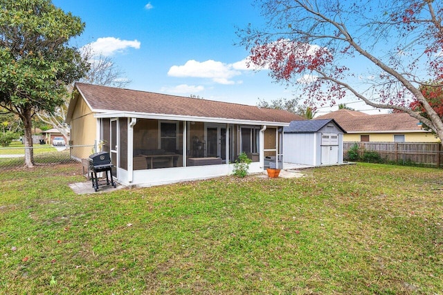 back of property featuring a lawn and a sunroom