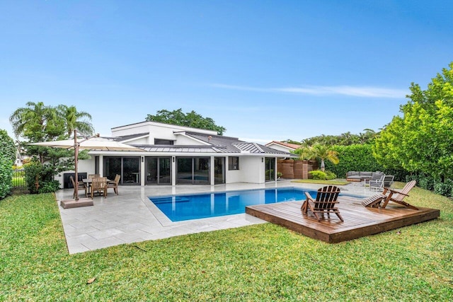 view of swimming pool with an outdoor living space, a yard, and a patio