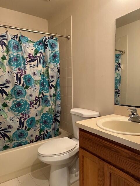 full bathroom with toilet, tile patterned flooring, vanity, and shower / tub combo with curtain