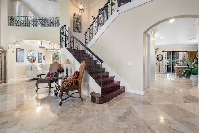 staircase featuring a towering ceiling