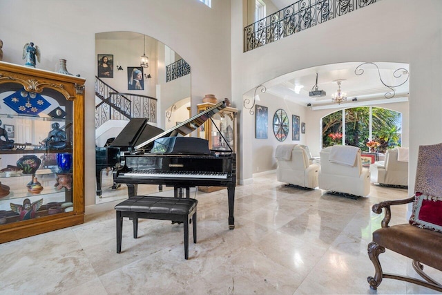 interior space with an inviting chandelier and a towering ceiling