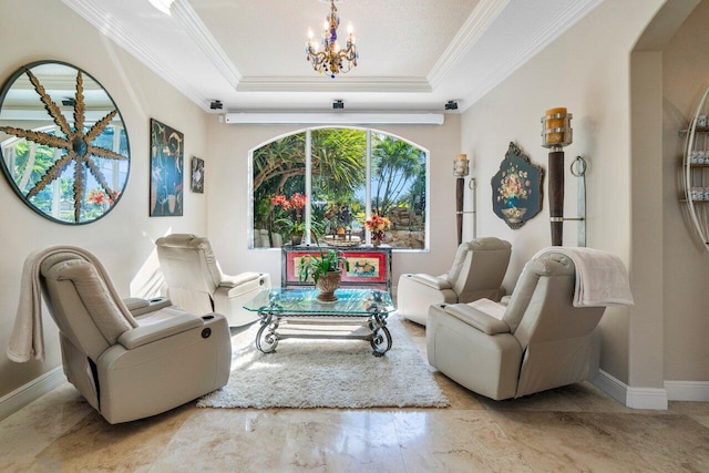 living area with crown molding, a notable chandelier, and a tray ceiling