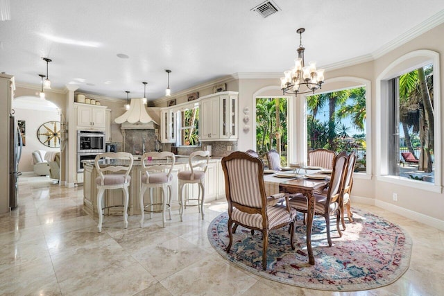 dining room featuring crown molding and a notable chandelier