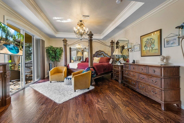 bedroom featuring crown molding, dark hardwood / wood-style floors, a raised ceiling, a notable chandelier, and access to exterior