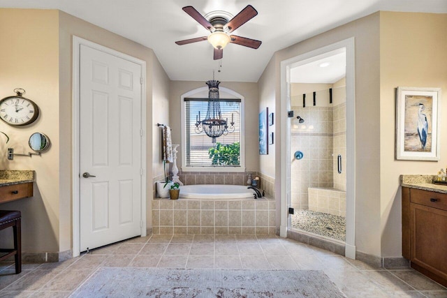 bathroom with tile patterned flooring, vanity, separate shower and tub, and ceiling fan with notable chandelier