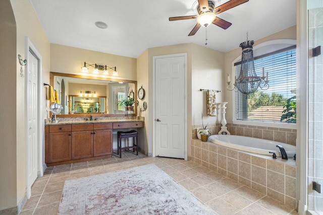 bathroom with ceiling fan, vanity, tiled bath, and tile patterned flooring