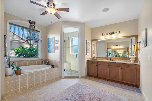 bathroom with independent shower and bath, vanity, a wealth of natural light, and tile patterned floors