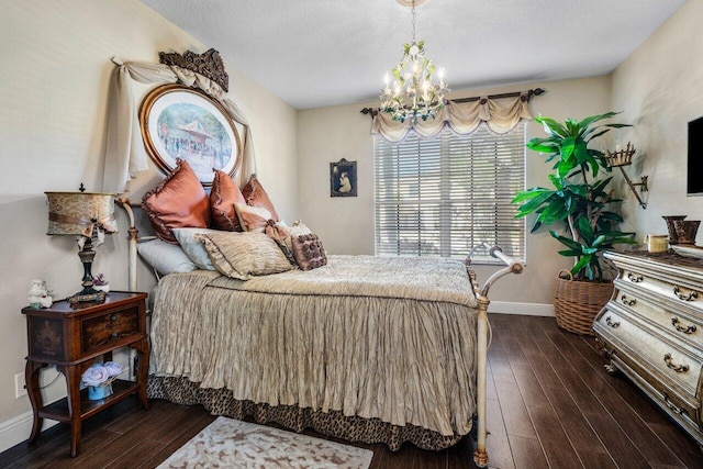 bedroom with a notable chandelier and dark hardwood / wood-style flooring