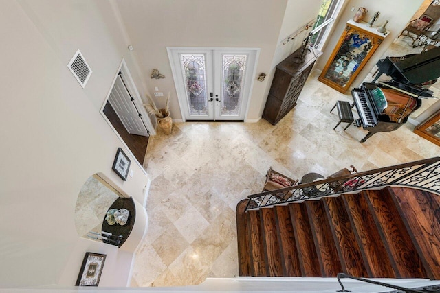 living room with french doors and a high ceiling