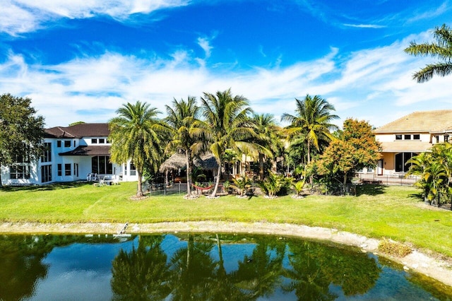 exterior space featuring a water view and a lawn