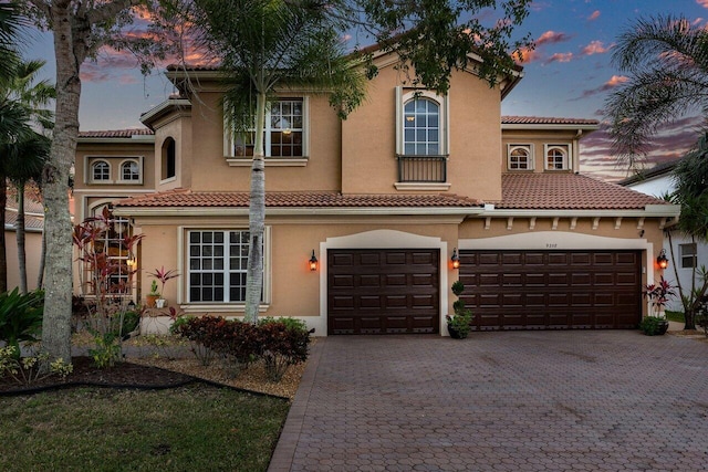 mediterranean / spanish home featuring a garage