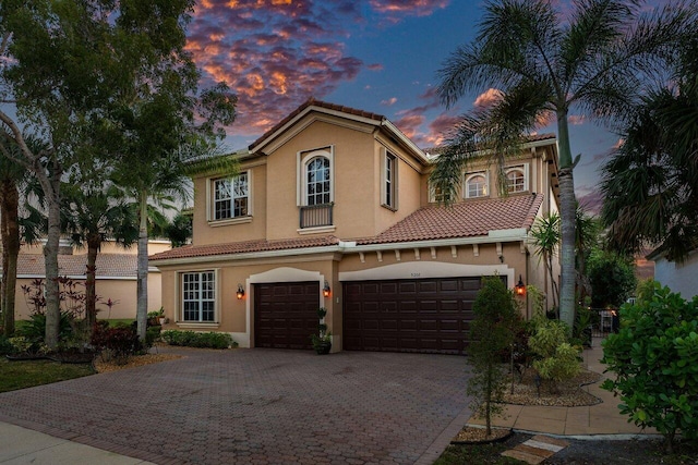 mediterranean / spanish-style home with a garage