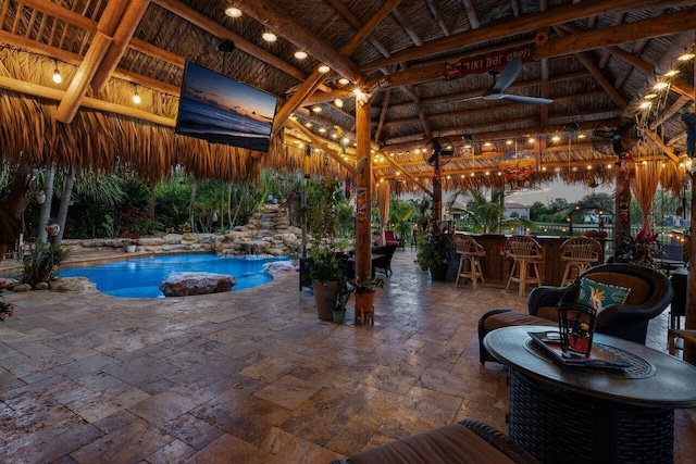 view of swimming pool with a gazebo, ceiling fan, an outdoor bar, and a patio