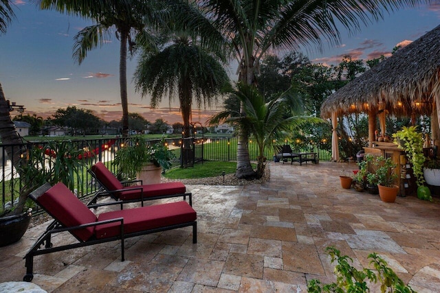 patio terrace at dusk featuring a gazebo