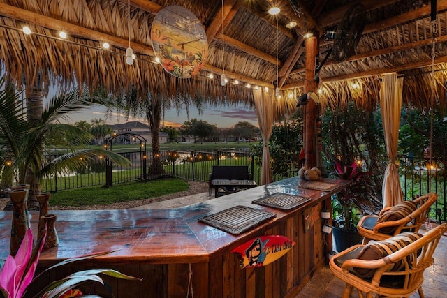 patio terrace at dusk with a bar and a gazebo