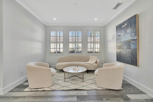 sitting room with crown molding and hardwood / wood-style floors