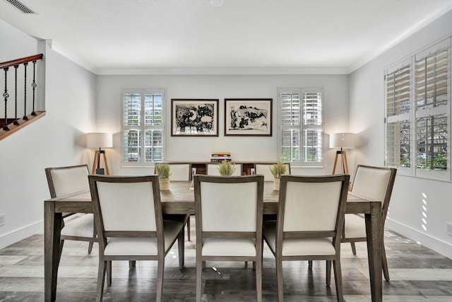 dining room featuring ornamental molding and wood-type flooring