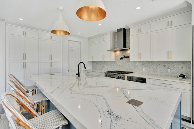 kitchen featuring white cabinets and wall chimney exhaust hood