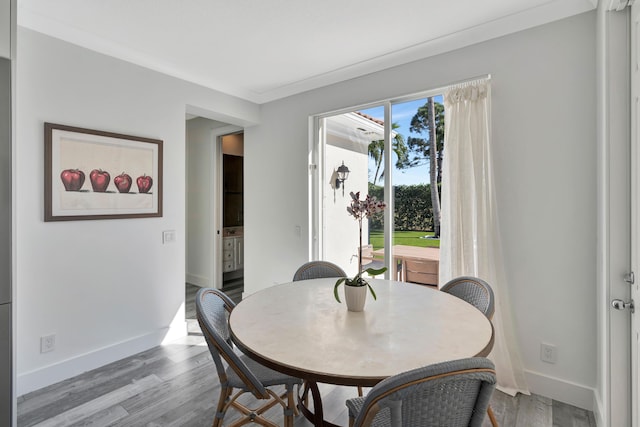 dining room featuring crown molding and hardwood / wood-style flooring