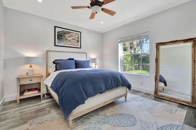 bedroom featuring crown molding, ceiling fan, and hardwood / wood-style flooring