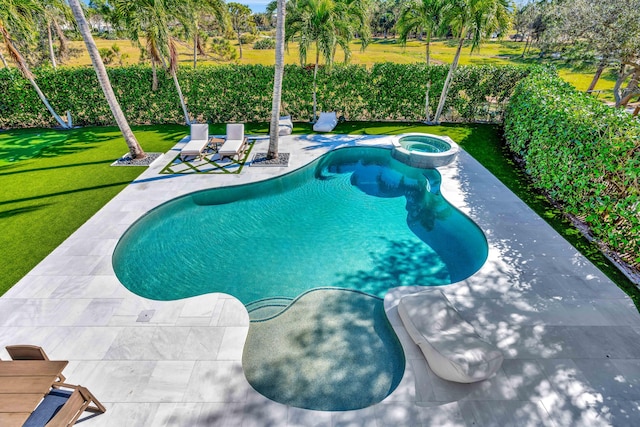 view of pool with an in ground hot tub, a patio, and a lawn