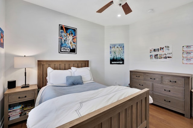 bedroom with light hardwood / wood-style flooring and ceiling fan