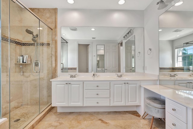 bathroom with vanity and a shower with door