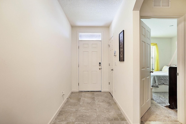 corridor with a textured ceiling